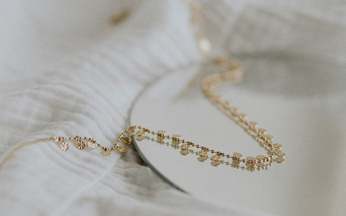 Paperclip chain necklace laid on white linen