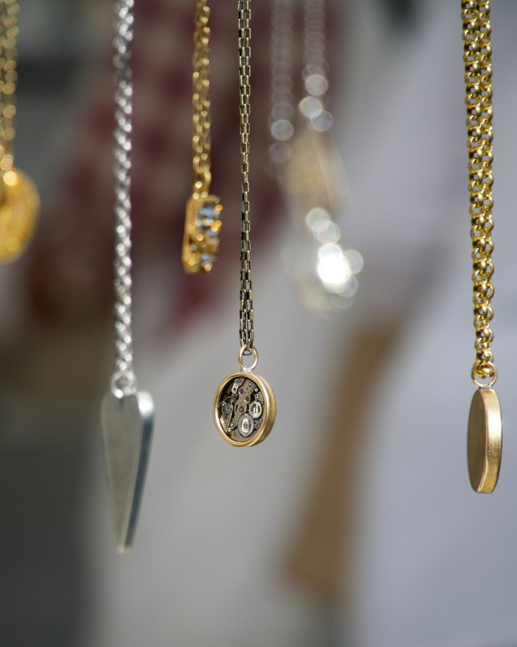 Pendant necklaces hanging in a row