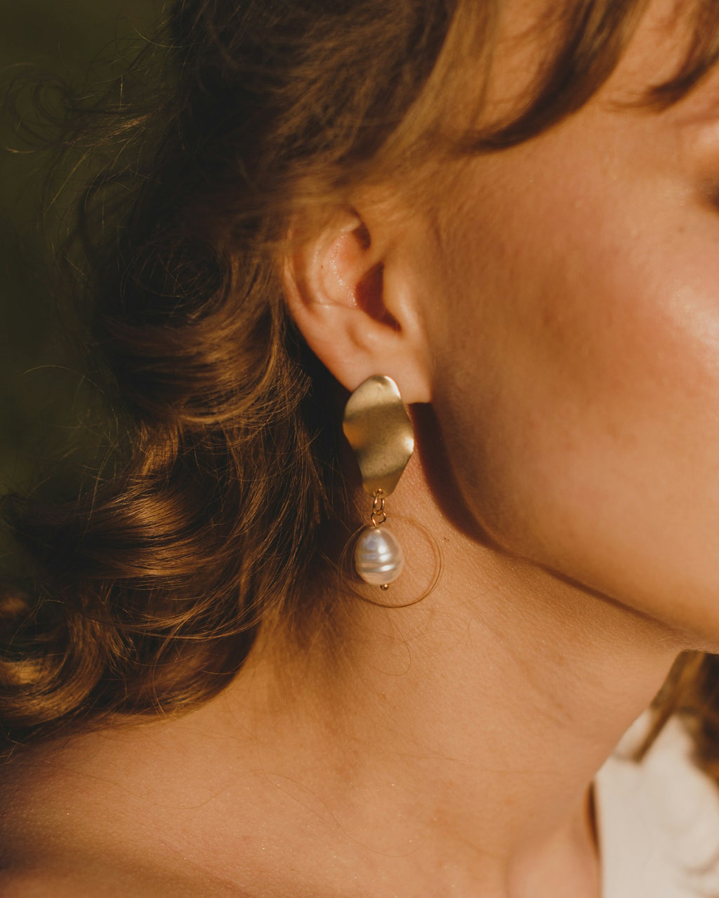 Pearl earring worn on the ear