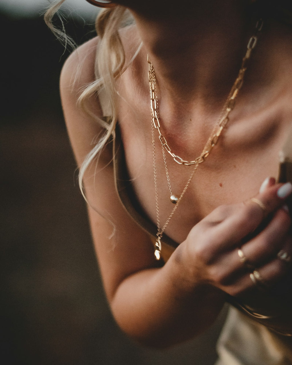Twin layer necklace worn with a camisole