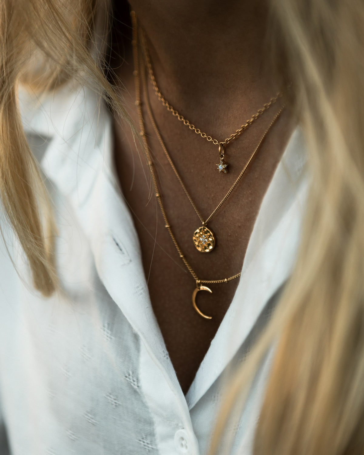 Heart charm necklace layered with fine chains
