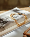 Gold chain bracelet on a magazine