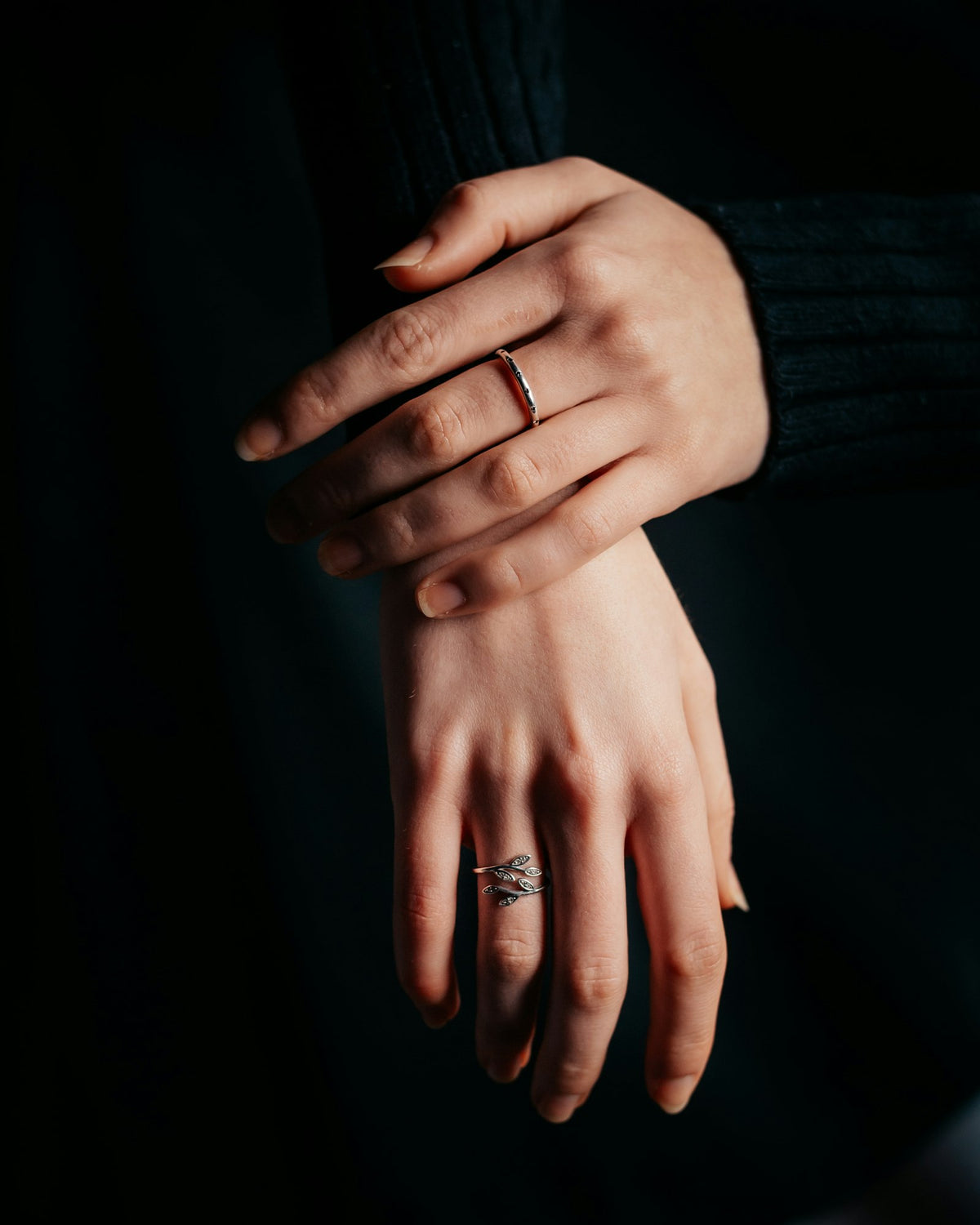 Hands wearing silver rings