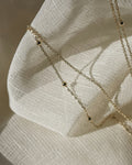 Fine body chain laid on linen