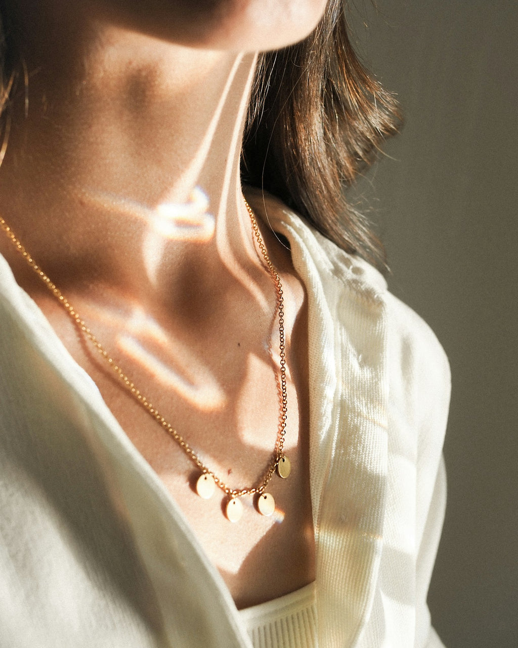 Chain necklace worn with a white shirt