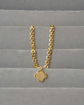 Gold chain with a pendant on fabric