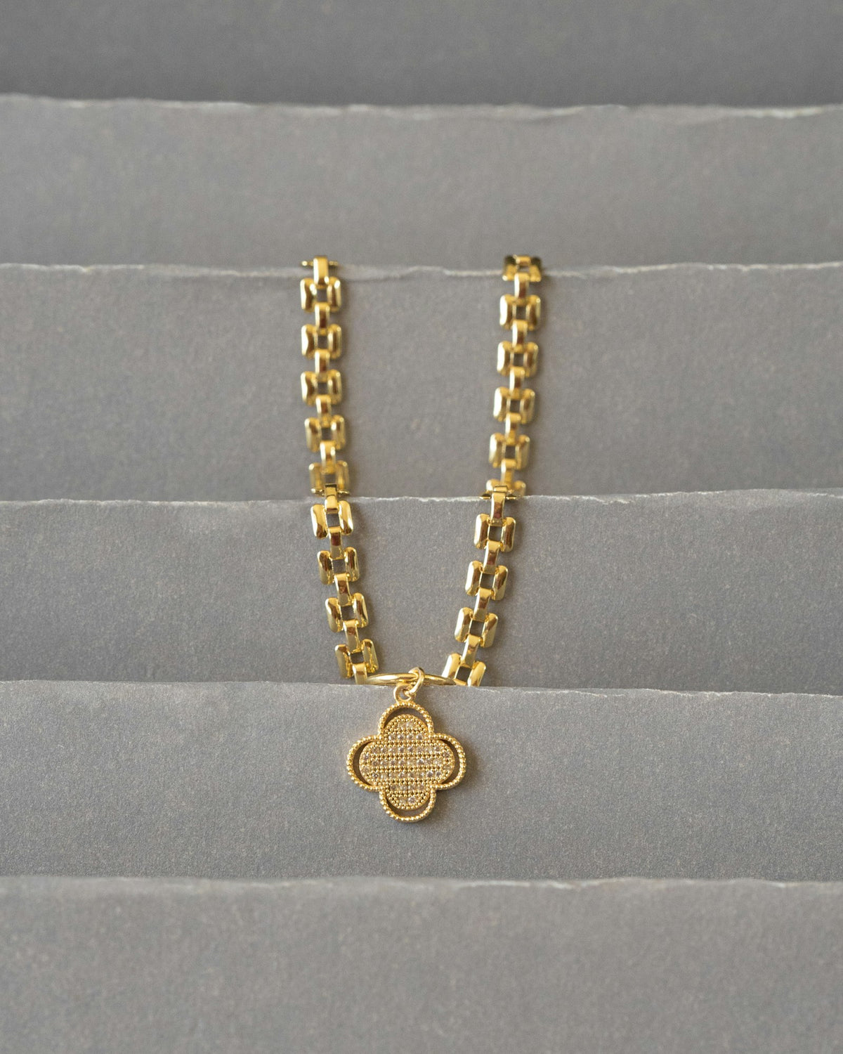 Gold chain with a pendant on fabric