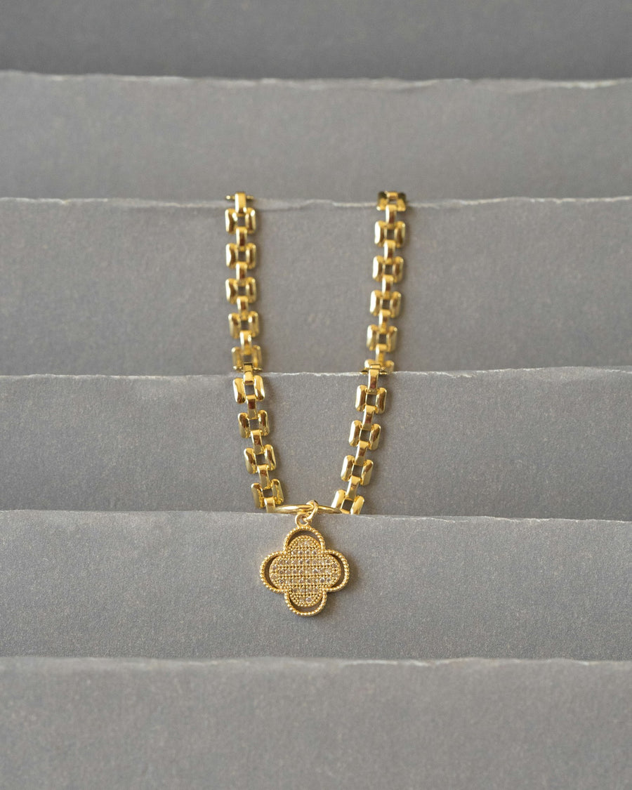 Gold chain with a pendant on fabric