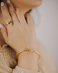 Gold ring and bracelet worn on the hand