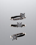 Three diamond rings set on a table