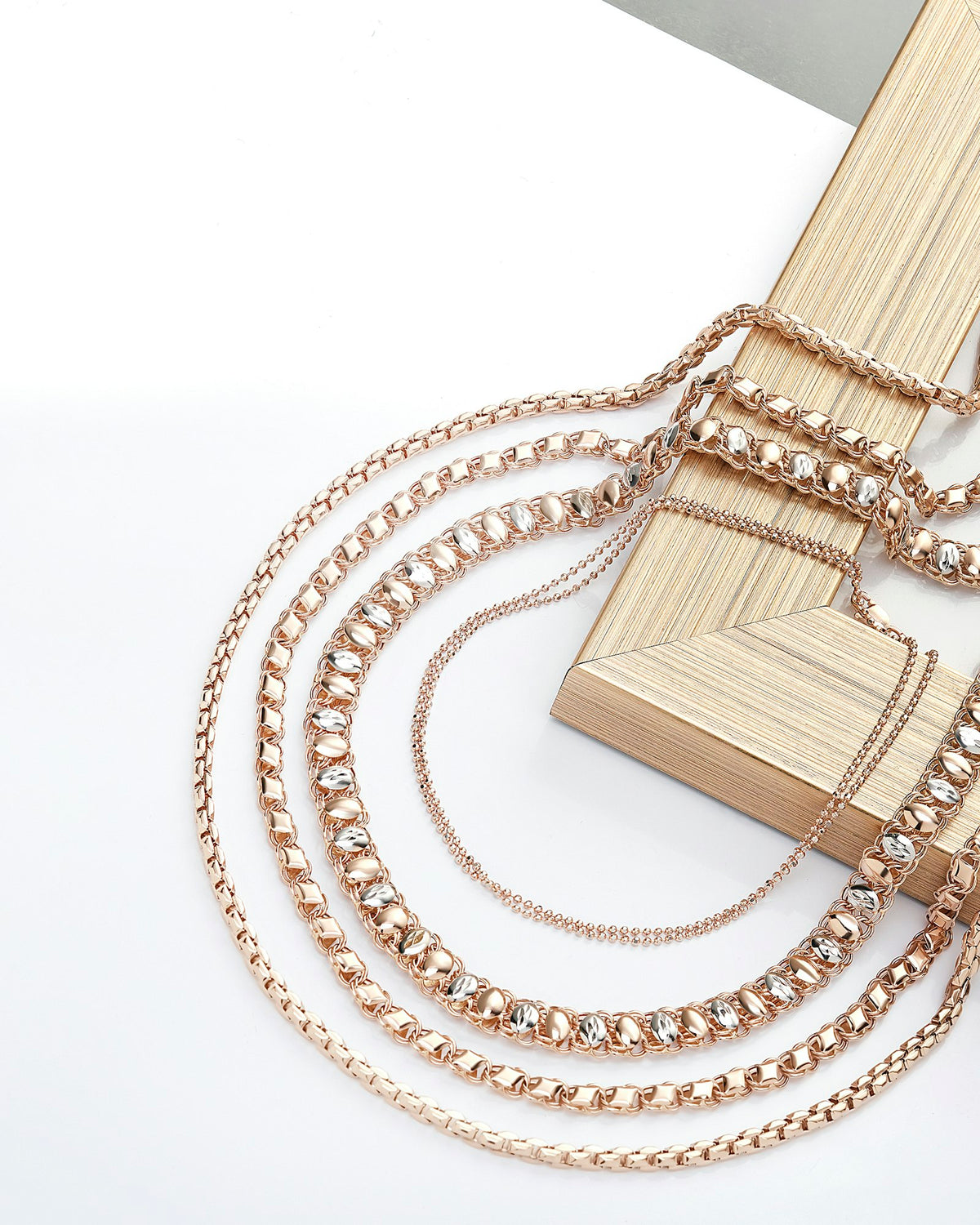 Fine chain bracelets arranged together