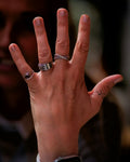Fine rings stacked across the fingers