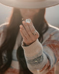 Hand wearing a cushion signet ring