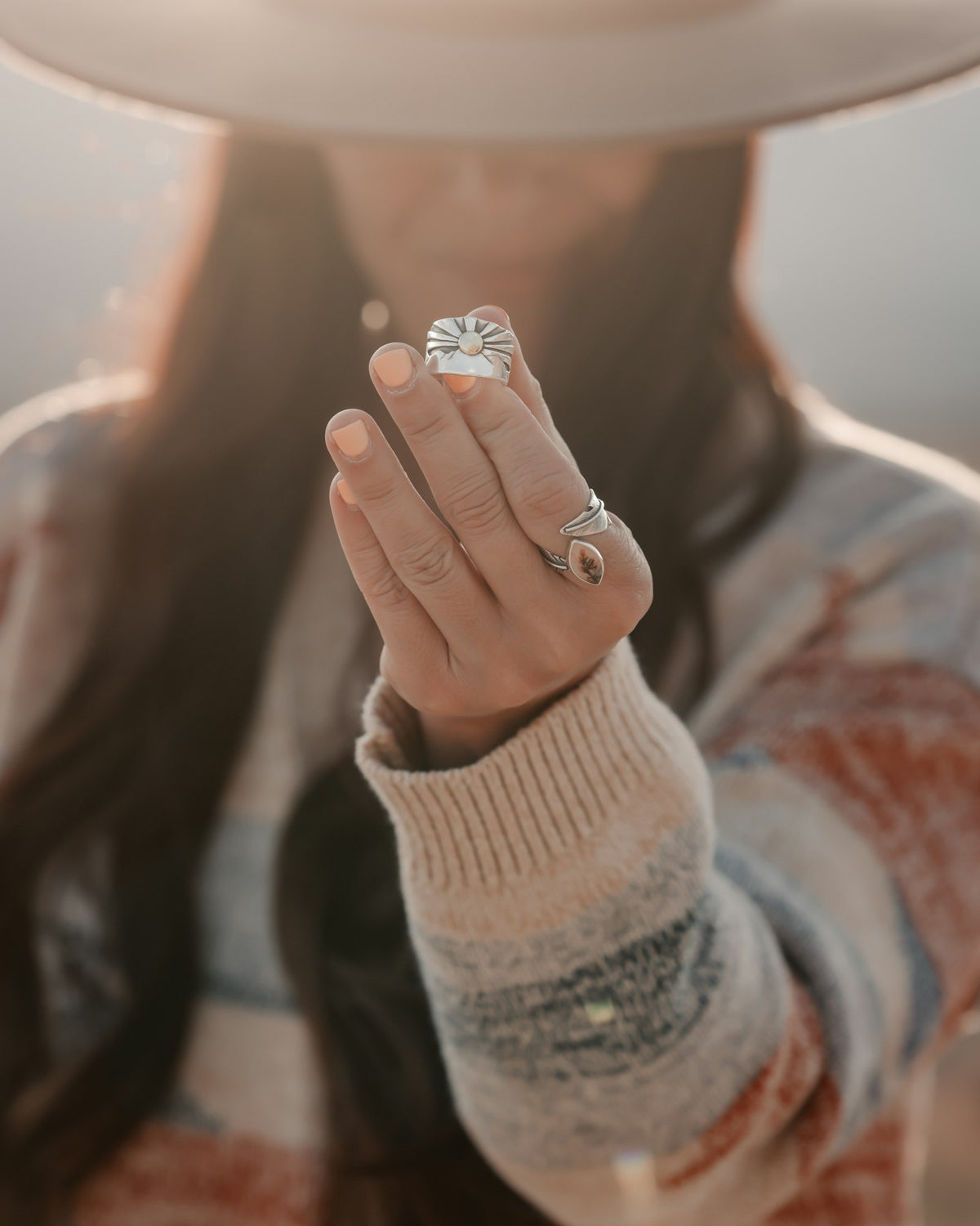 Hand wearing a cushion signet ring