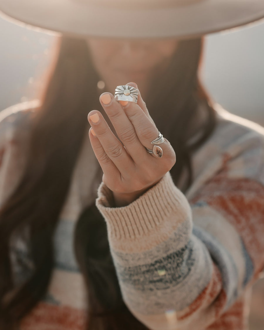Hand wearing a cushion signet ring