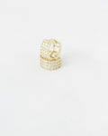 Gold hoop earrings with sparkling stones on white