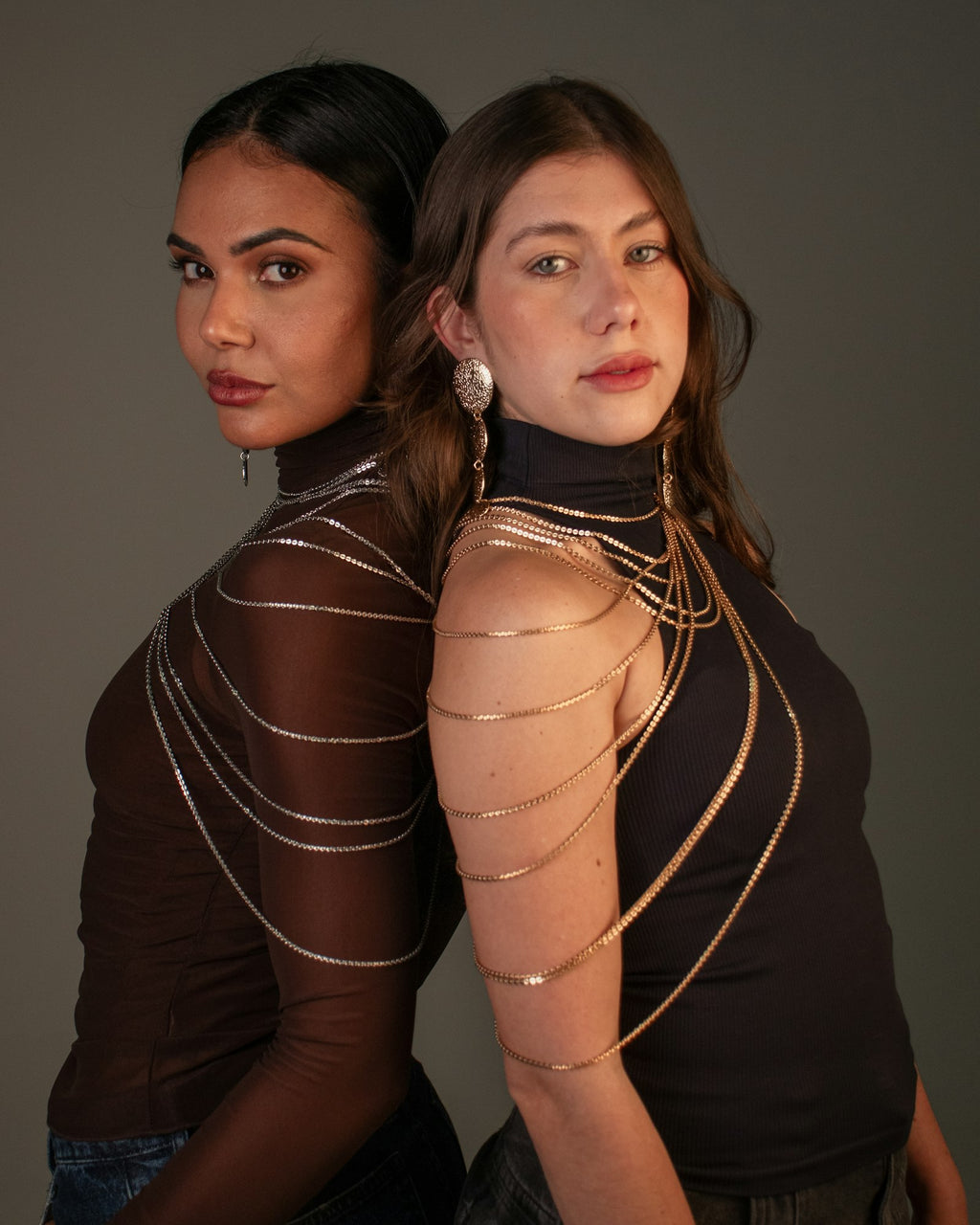 Layered chains worn over dark tops